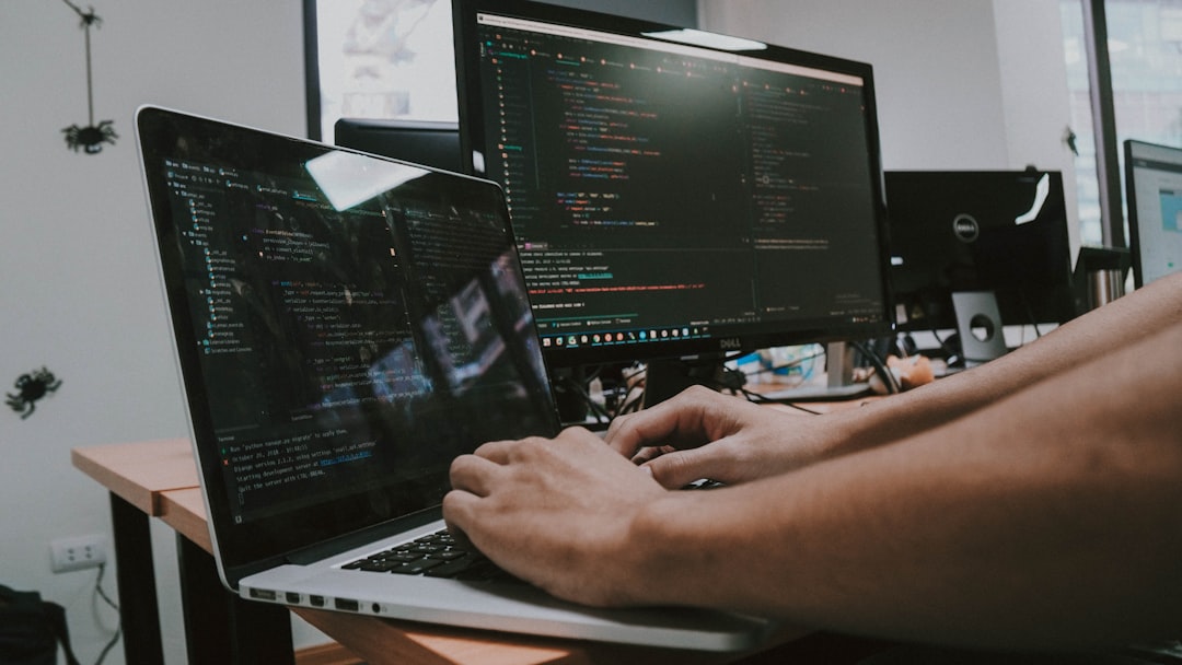 a-person-typing-on-a-laptop-computer-on-a-desk-uhx-ghppcdg